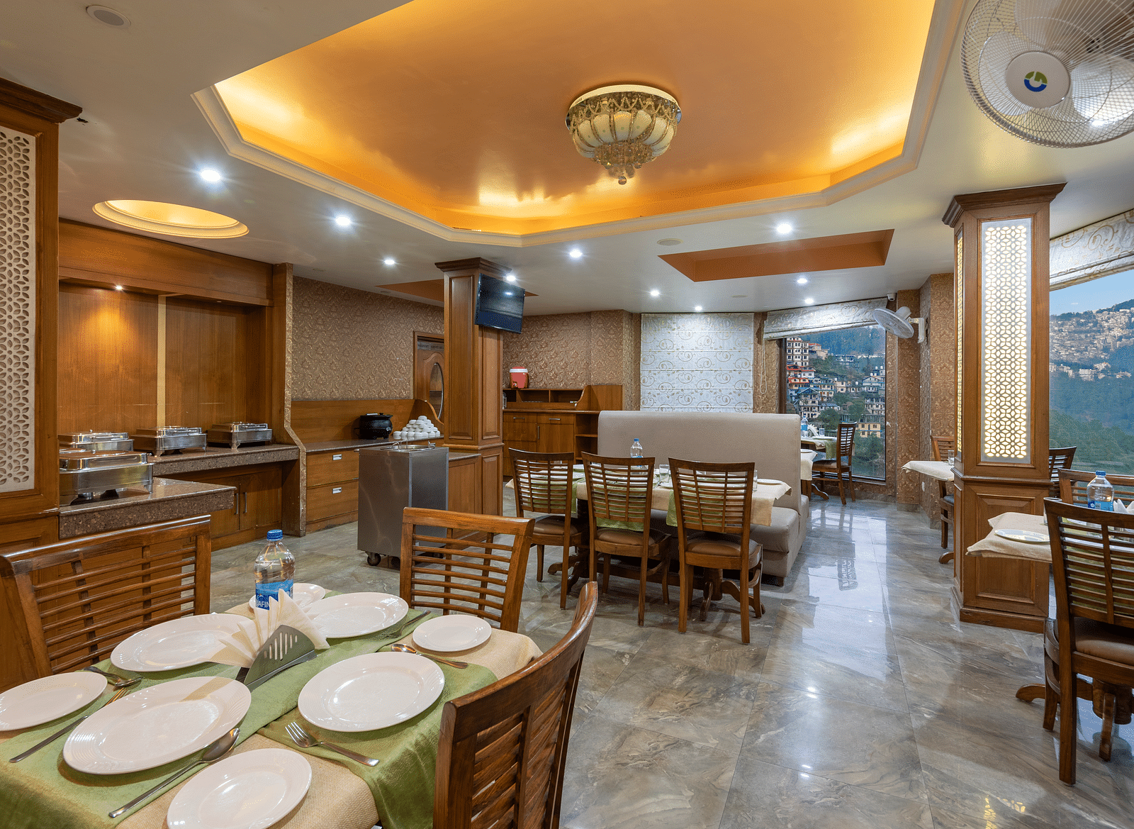 Dining area with a table set for a meal, featuring chairs and plates neatly arranged on the table at DLS Hotels The Rock Castle.